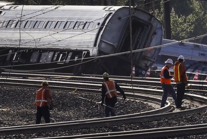 Pekerja sedang melakukan pengecekan terhadap peristiwa anjloknya kereta Amtrak di Philadelphia, Rabu (13/5).