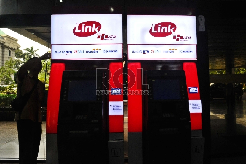  Pekerja sedang memasang unit baru ATM Himpunan Bank-Bank Milik Negara (Himbara) di perkantoran, Jakarta, Senin (7/12).