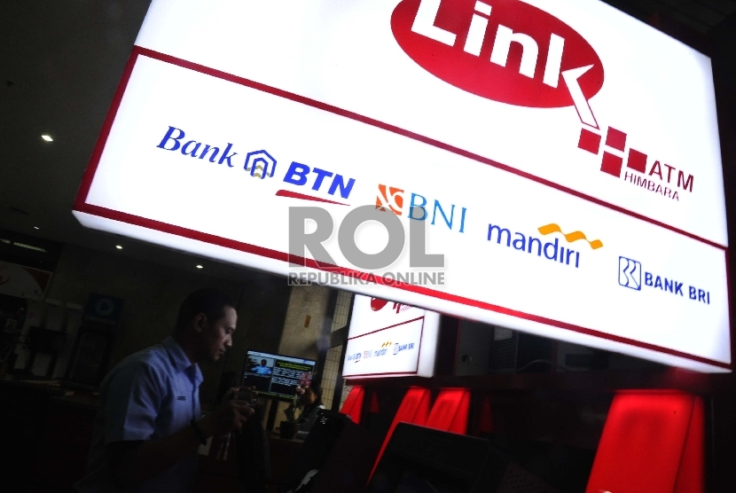  Pekerja sedang memasang unit baru ATM Himpunan Bank-Bank Milik Negara (Himbara) di perkantoran, Jakarta, Senin (7/12).