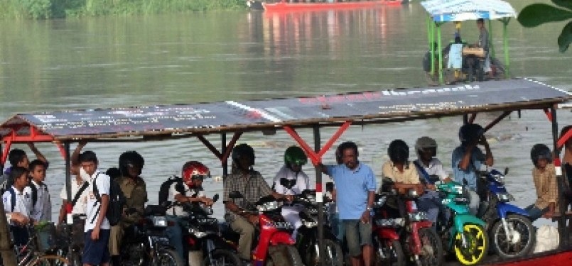 Pelajar dan warga menyeberang sungai dengan naik perahu. (ilustrasi)