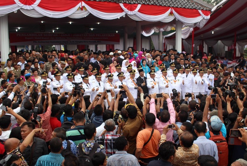 Pelatikan Gubernur Sumut Tengku Erry Nuradi (tengah) bersama sejumlah Bupati/Wakil Bupati dan Wali Kota/Wakil Wali Kota terpilih berfoto bersama usai  pelantikan di Lapangan Merdeka Medan, Sumatera Utara, Rabu (17/2)