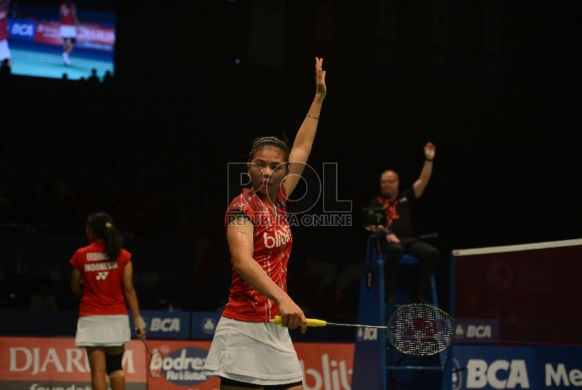 Pemain anda putri Indonesia Greysia Polii (kanan) mengangkat tangan memberikan tanda kok keluar saat melawan pasangan ganda putri Tiongkok Luo Ying dan Luo Yu dalam babak perempat final turnamen bulutangkis BCA Indonesia Open Superseries Premier 2015 di Is