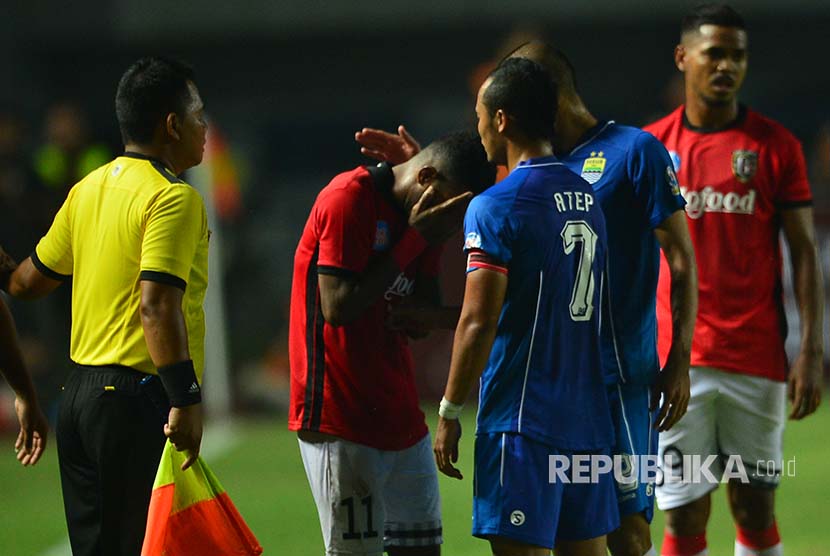 Pemain Bali United menutup muka saat berdiskusi dengan kapten tim Persib Atep Rizal usai insiden tendangan bola Yabes kepada Essien dalam laga persahabatan di Stadion GBLA Bandung, Sabtu (8/4).