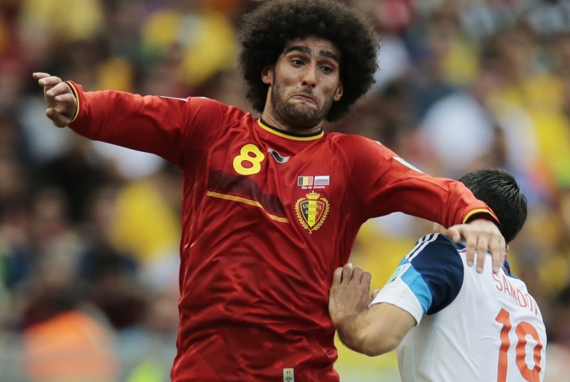 Pemain Belgia Marouane Fellaini beradu memperebutkan bola dengan pemain Rusia Alexander Samedov