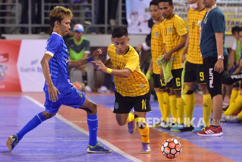 Pemain futsal Jabar Jeni Firmansyah (biru) berebut bola dengan pemain futsal Maluku Utara Fandy Achmad pada Final Futsal PON XIX Jabar 