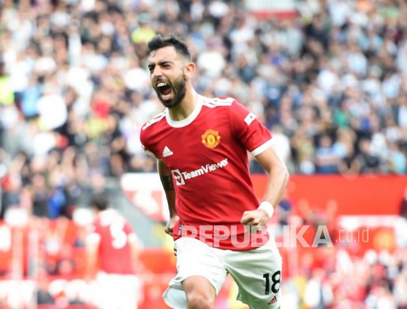 Pemain Manchester United Bruno Fernandes merayakan setelah mencetak gol ketiga timnya pada pertandingan sepak bola Liga Premier Inggris antara Manchester United dan Newcastle United di Manchester, Inggris, Sabtu (11/9).