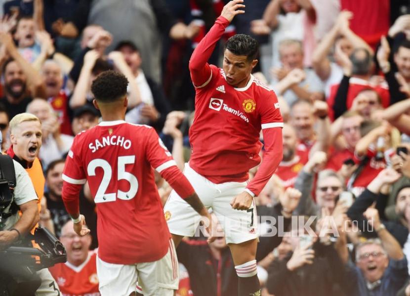 Pemain Manchester United  Cristiano Ronaldo (kanan) merayakan mencetak gol kedua timnya dengan Jadon Sacho pada pertandingan sepak bola Liga Premier Inggris antara Manchester United dan Newcastle United di Manchester, Inggris, Sabtu (11/9).