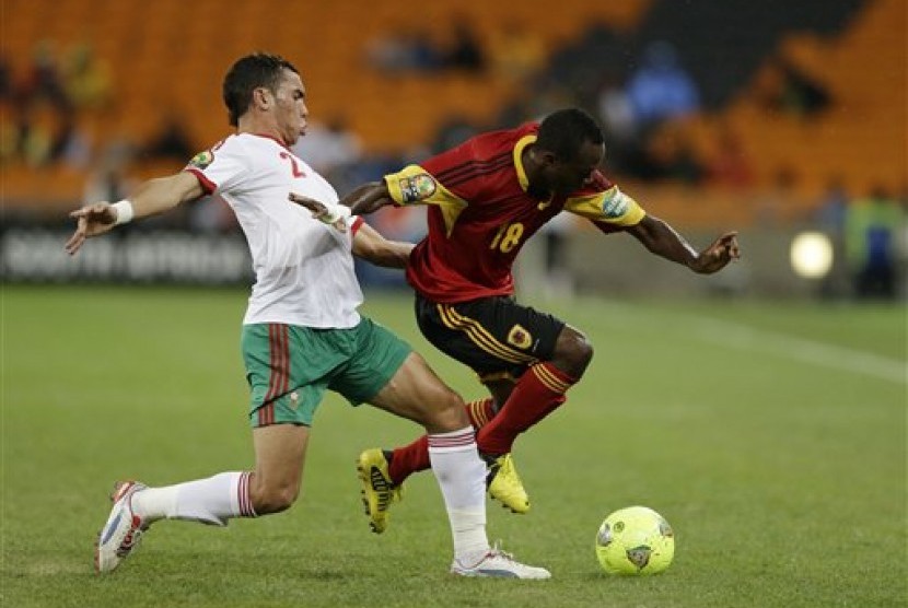 Pemain Maroko Abderrahim Achchakir (kiri) berduel dengan pemain Angola 'Geraldo' Bartolomeu pada laga perdana Grup A Piala Afrika di Johannesburg, Afrika Selatan, Sabtu (19/1).