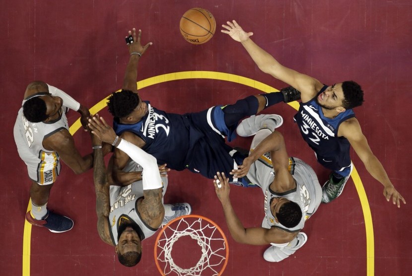 Pemain Minnesota Timberwolves, Karl-Anthony Towns (kanan), coba mengambil bola saat menghadapi Cleveland Cavaliers di laga basket NBA di Cleveland pada Rabu (7/2). 