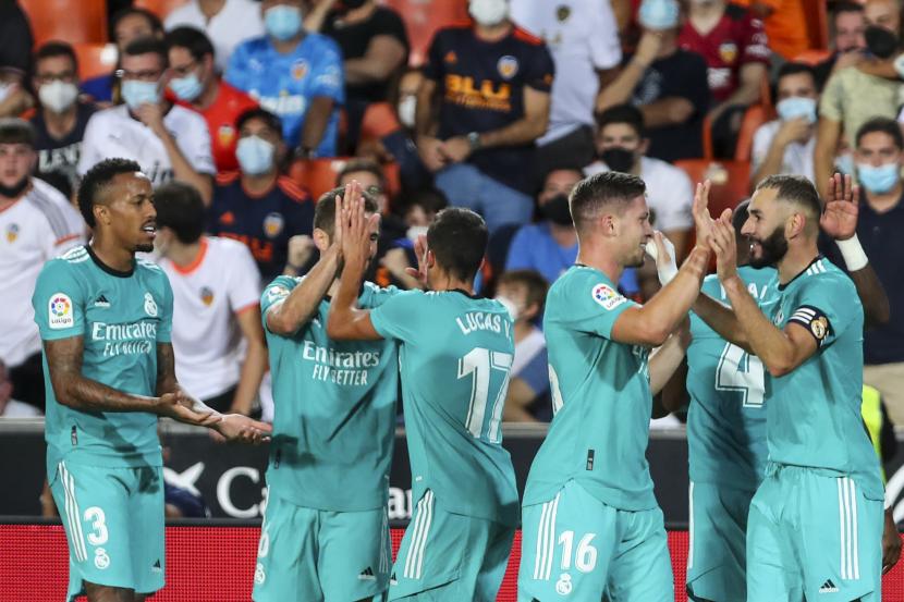 Para pemain Real Madrid merayakan gol selama pertandingan sepak bola La Liga Spanyol antara Valencia dan Real Madrid di Stadion Mestalla di Valencia, Spanyol, Ahad, 19 September 2021.