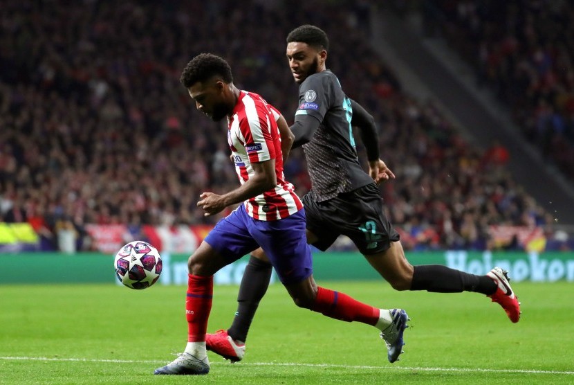 Pemain sayap Atletico Madrid Thomas Lemar (kiri) berebut bola dengan bek Liverpool Joe Gomez (kanan)