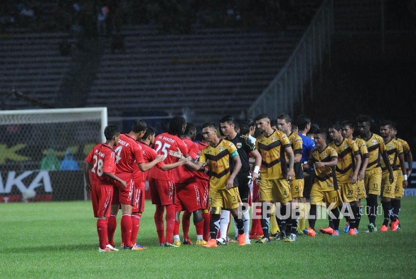 Pemain Semen Padang (merah) bersalaman dengan pemain Mitra Kukar (kuning) saat laga Final Piala Sudirman yang digelar di Jakarta, Ahad (24/1). 