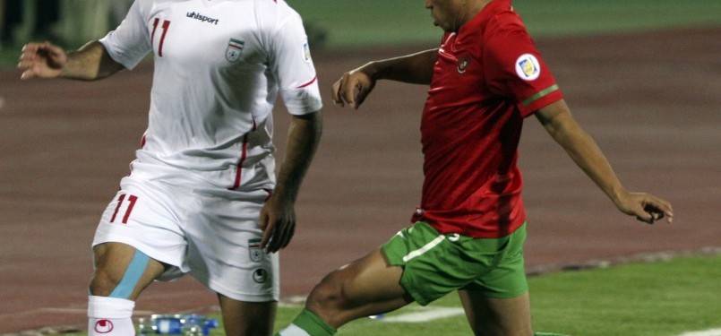 Pemain Timnas Indonesia, Benny Wahyudi  (kanan) mencoba menghadang pergerakan  pemain Timnas Iran Gholam Reza (kiri) dalam pertandingan kualifikasi Grup E Asia Pra Piala Dunia di Teheran, Jumat malam. Iran menang telak 3-0.