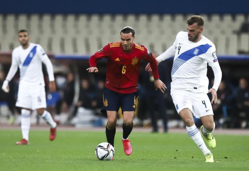 Pemain timnas Spanyol Raul de Tomas (tengah) membawa bola dijaga pemain Yunani Dimitris Goutas dalam laga kualifikasi Piala Dunia 2022 di Athena, Yunani, Jumat (12/11) dini hari WIB. Spanyol menang 1-0 lewat penalti Pablo Sarabia dan naik ke puncak Grup B.