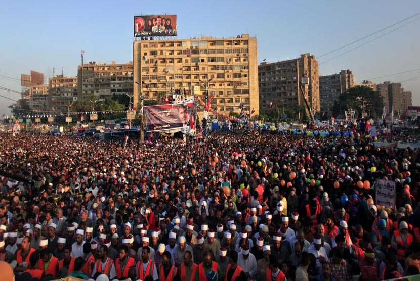  Pendukung Presiden Muhammad Mursi melaksanakan Shalat Idul Fitri memadati jalan raya di luar Masjid Rabaah al-Adawiya, Nasr City, Kairo, Kamis (8/8).  (AP/Khalil Hamra) 