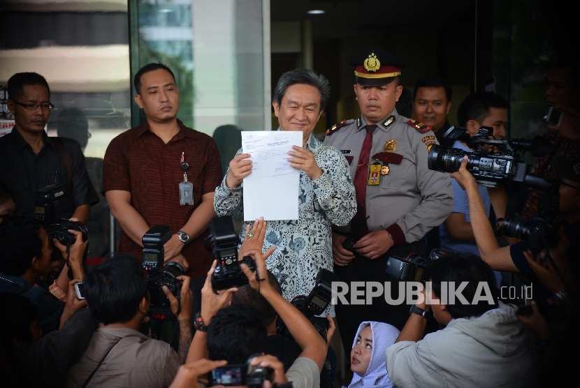  Pengacara mantan Direktur Pelindo II RJ Lino, Maqdir Ismail (tengah) menunjukan surat keterangan kliennya yang sedang sakit jantung untuk diberikan ke KPK, Jakarta, Jumat (29/1). (Republika/Raisan Al Farisi)