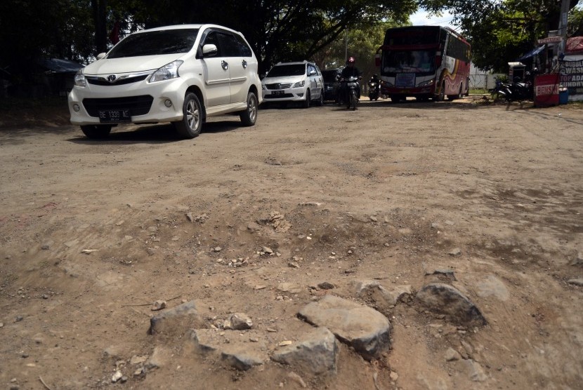 Pengendara memperlambat laju kendaraannya saat melintasi jalan rusak, di Jalan Ryacudu Sukarame, Bandar Lampung, Lampung (Ilustrasi)