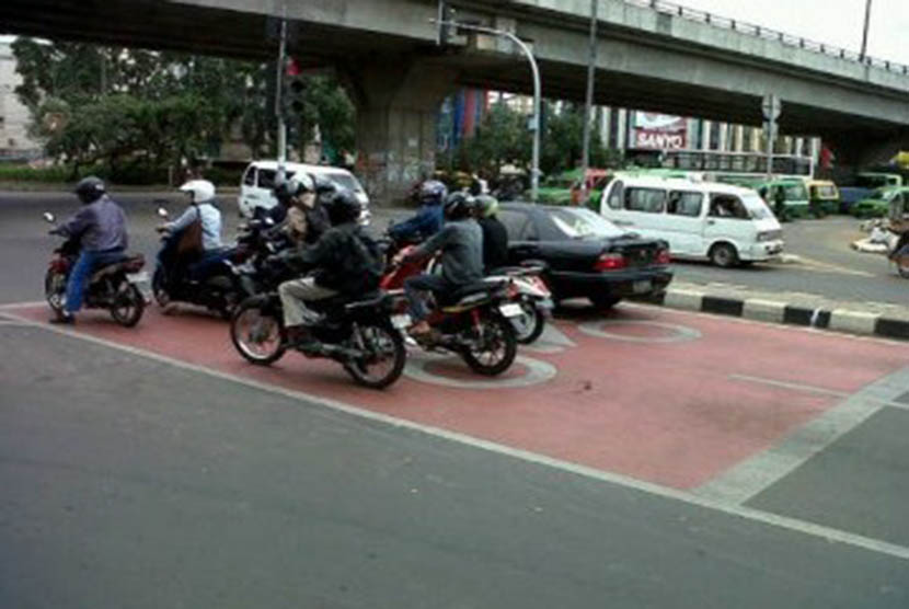 Pengendara motor saat berhenti di Red Box di Jalan Sudirman, Tangerang, Jumat (30/12).