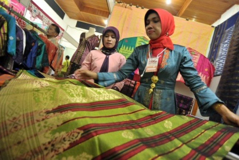 Pengrajin menunjukan kain songket karyanya, saat pameran Sawahlunto International Songket Carnival (SISCa) 2017, di Sawahlunto, Sumatera Barat, Jumat (25/8). Pameran tersebut menampilkan songket karya pengrajin lokal dan karya dari Riau, Palembang, Kalimantan, serta sejumlah daerah lainnya di nusantara. 