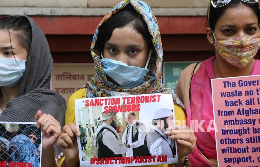Pengungsi perempuan Afghanistan memegang plakat saat mereka berpartisipasi dalam protes di New Delhi, India,Senin (23/8). Ratusan aktivis dari berbagai organisasi kiri dan pengungsi Afghanistan mengadakan protes menentang pengambilalihan Taliban atas Afghanistan dan menuntut untuk melindungi perempuan Afghanistan. 