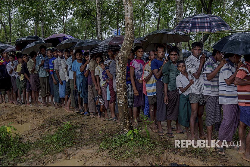 Pengungsi Rohingya mengantre bantuan beras yang dibagikan lembaga bantuan di Balukhali-Ukhiya, Bangladesh