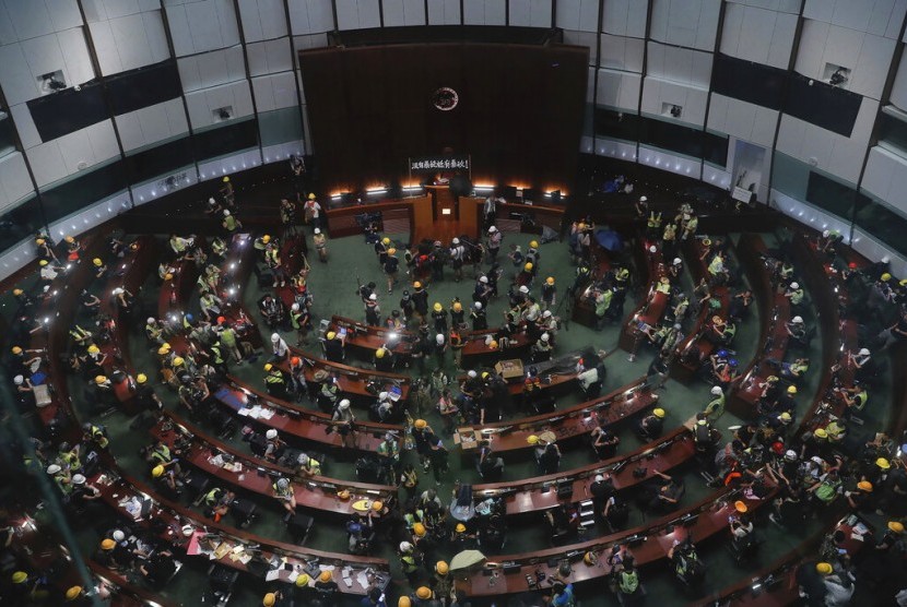 Pengunjuk rasa memasuki dan berkumpul di ruang pertemuan Dewan Legislatif di Hong Kong, Senin (1/7).