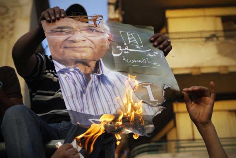  Pengunjuk rasa membakar poster calon presiden Mesir Ahmad Ahmed Shafiq di Kairo, Mesir. 