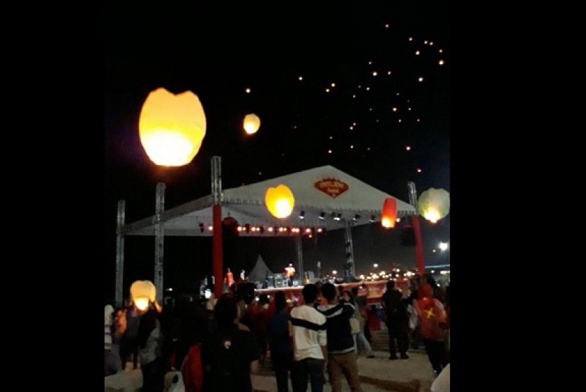 Pengunjung Ancol menyalakan lampion di Pantai Lagoon, Jakarta, Jumat (16/2).