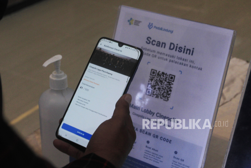Pengunjung bioskop melakukan check in melalui aplikasi peduli lindungi ketika hendak masuk ke kawasan bioskop di Kota Kupang, NTT, Jumat (7/1/2022). (ilustrasi)
