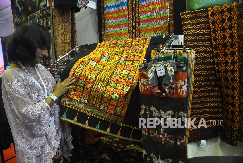 Pengunjung melihat kain tenun dalam pameran Telkom Craft Indonesia di Jakarta Convention Center (JCC), Senayan, Jakarta, Jumat (10/3).