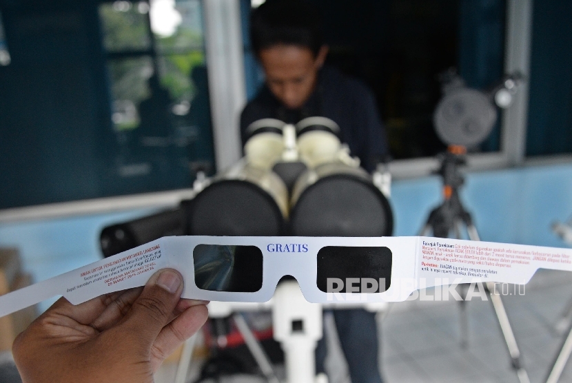 Pengunjung mencoba kacamata dan teleskop untuk melihat gerhana matahari di Planetarium dan Observatorium, Taman Ismail Marzuki (TIM), Jakarta, Senin (7/3).