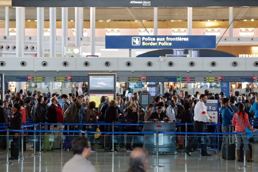 Penumpang mengantre pemeriksaan polisi perbatasan Prancis di Bandara Charles de Gaulle, (14/11). Menyusul teror di Paris pemerintah memperketat pemeriksaan bahkan menutup perbatasan Prancis.
