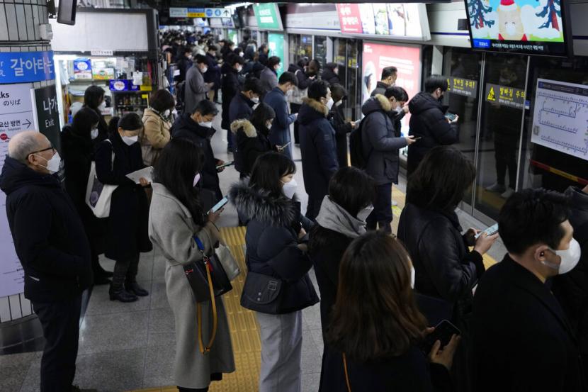Penumpang menunggu kedatangan kereta bawah tanah di sebuahbstasiunbdi Seoul, Korea Selatan.