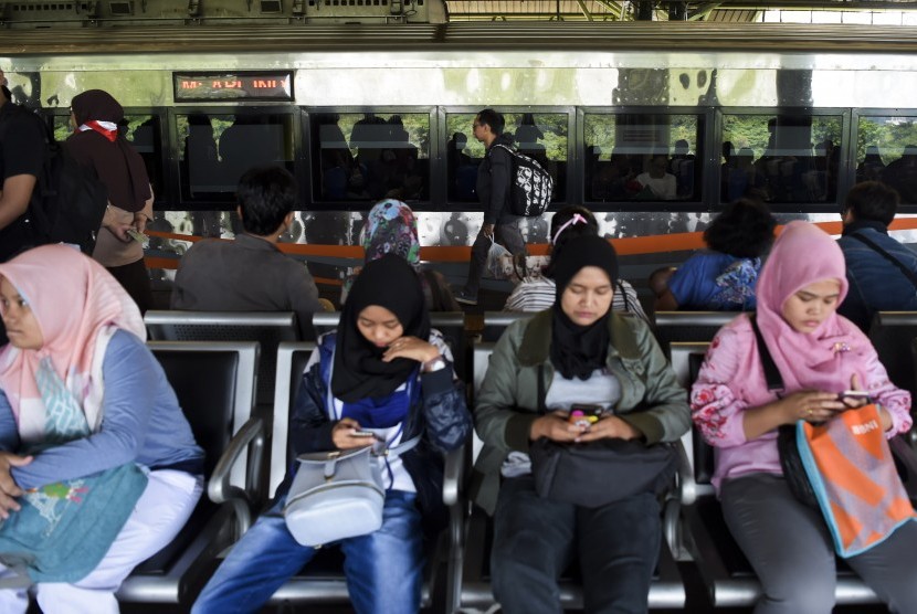 Penumpang menunggu kedatangan kereta di Stasiun Gambir, Jakarta, Sabtu (1/6/2019). 