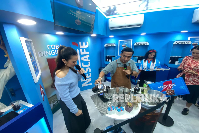 Penyanyi solo Raisa (kiri) terlihat hendak meracik kopi di self-station booth Nescafe di sela-sela Prambanan Jazz Festival, Jumat (4/7/2025).