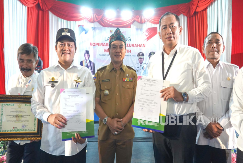 Penyerahan berita acara serah terima bantuan oleh RCEO BRI Regioan 9 Bandung Sadmiadi kepada Kepala Desa Cileunyi Wetan H. Hari Haryono disaksikan Bupati Bandung H. M. Dadang Supriatna.