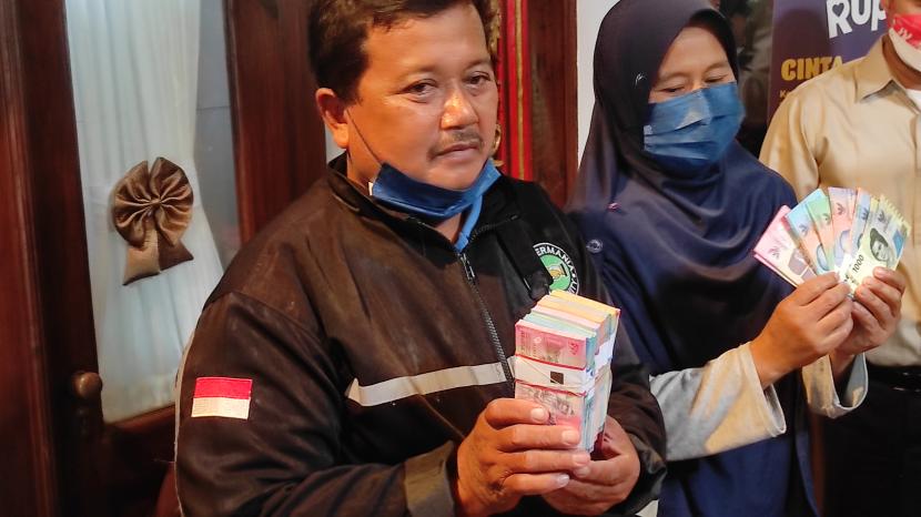 Penyerahan uang dari hasil rekontruksi sisa-sisa yang dimakan rayap kepada Samin, Kamis (15/9/2022).