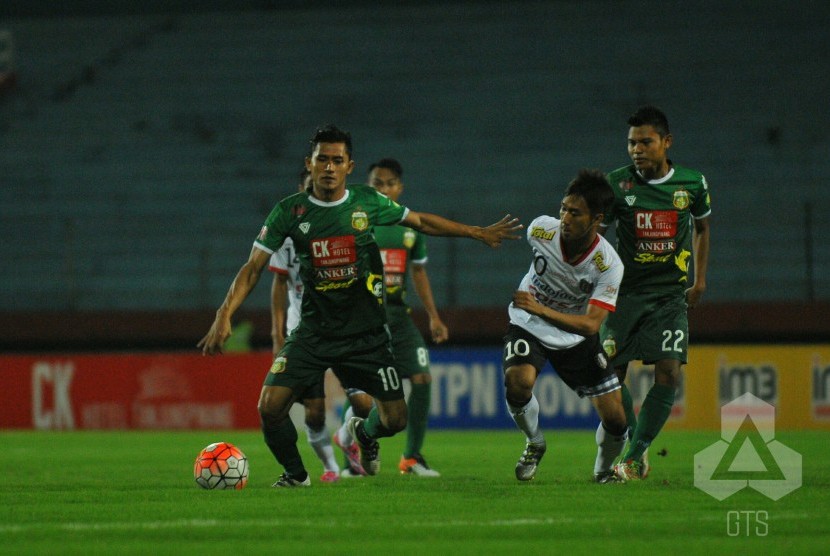 Penyerang Bhayangkara Surabaya United Rudi Widodo (kiri) membawa bola dikejar pemain Bali United.