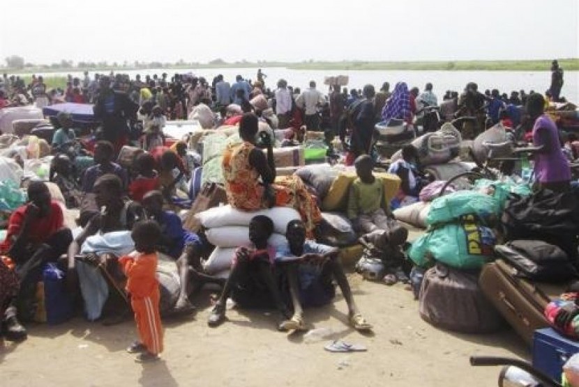 People displaced from fighting between the South Sudanese army and rebels, wait for boats to cross the Nile River, in Bor town, around 180 km (112 miles), northwest from the capital of Juba December 30, 2013.