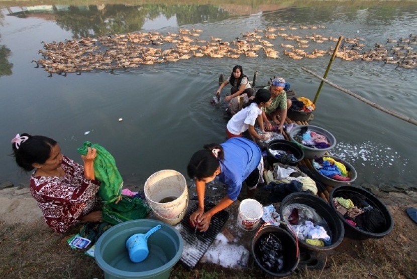 People wash clothes at the river in Karawang, West Java.   