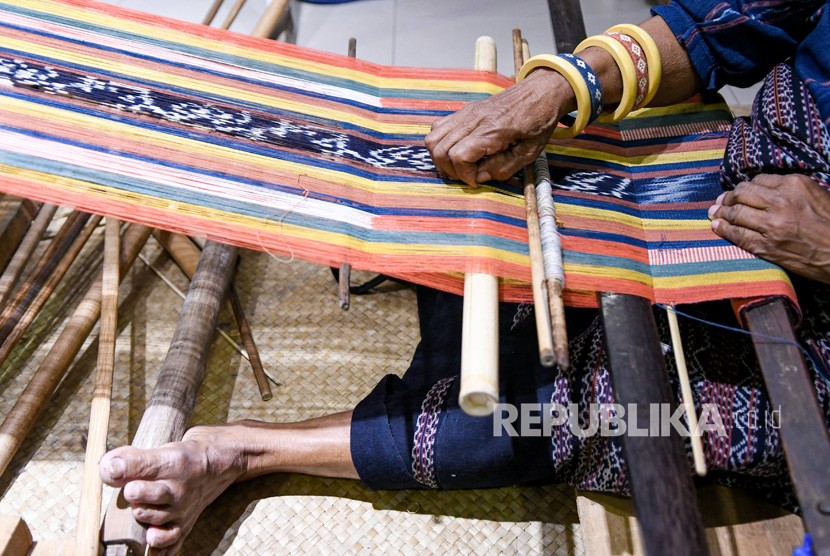 Perajin memproduksi kain tenun ikat Sikka asal Maumere, NTT. Perlindungan terhadap karya-karya budaya para kaum perempuan di NTT dipandang sangat penting.