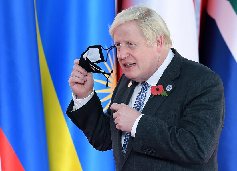 Perdana Menteri Inggris Boris Johnson melepas masker saat tiba untuk menghadiri KTT Pemimpin G20 di Pusat Kongres La Nuvola di Roma, Italia, 30 Oktober 2021. 
