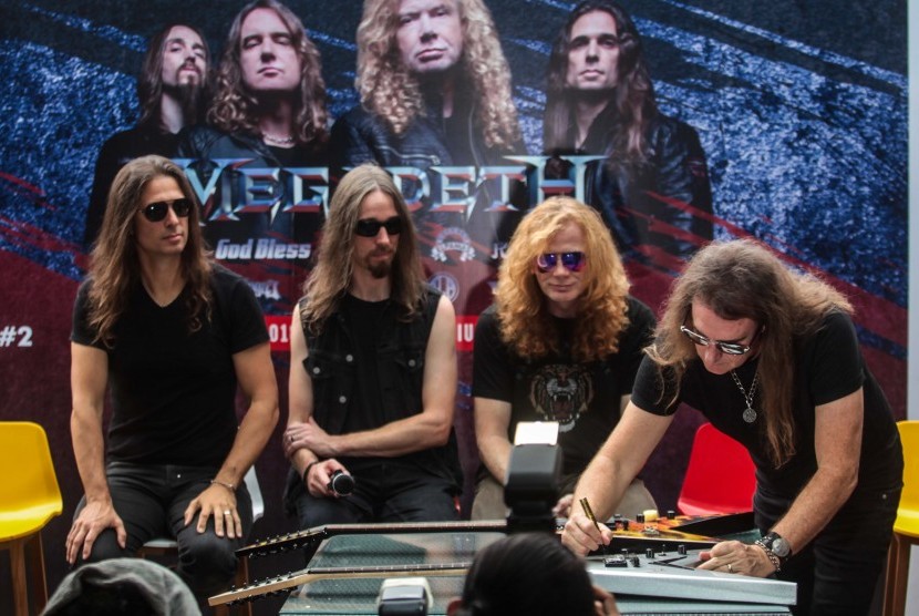 Personel grup band Megadeth Dave Mustaine (kedua kanan), Dirk Verbeuren (kedua kiri), Kiko Louleiro (kiri) danDavid Ellefson (kanan) menandatangani gitar yang akan dilelang untuk korban bencana Palu saat jumpa pers jelang acara JogjaROCKarta : International Musik Festival 2018 di Yogyakarta, Jumat (26/10/2018). 