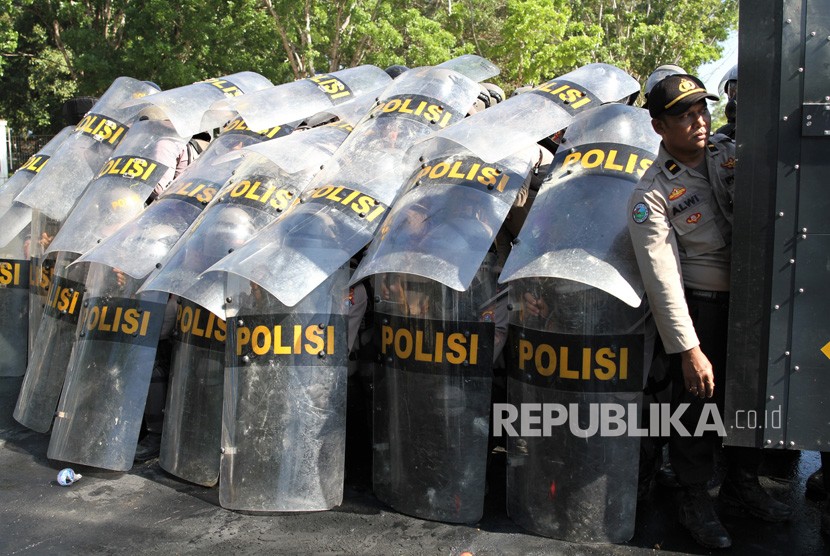 Personel Polda Sulawesi Tenggara membuat barikade saat berlangsungnya aksi menuntut penuntasan kasus kematian mahasiswa di depan Polda Sulawesi Tenggara, Kendari, Sulawesi Tenggara, Selasa (22/10/2019).