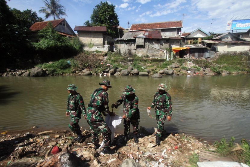 Personel TNI yang merupakan anggota Satgas Naturalisasi Sungai Ciliwung membersihkan sampah di bantaran Sungai Ciliwung Kota Bogor, Jawa Barat, Senin (4/2/2019). 