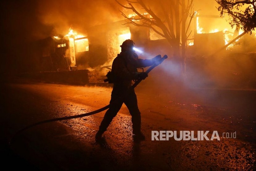Petugas pemadam berusaha menjinakkan api di Kalifornia, Los Angeles, AS, Senin (28/10) dini hari.