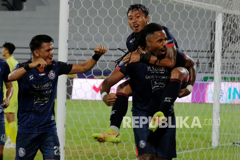 Pesepak bola Arema FC Carlos Fortes (kanan) bersama Kushedya Hari Yudo (tengah) dan Sandi Sute (kiri) berselebrasi usai mencetak gol ke gawang Persipura Jayapura pada pertandingan Liga 1 di Stadion Kapten I Wayan Dipta, Gianyar, Bali, akhir bulan lalu.
