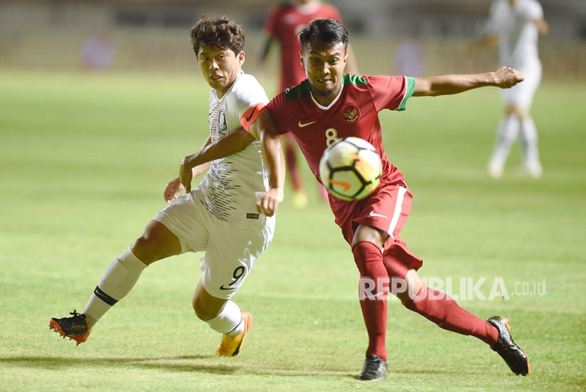 Pesepak bola Indonesia U-23 Muhammad Hargianto (kanan) berebut bola dengan pesepak bola Korsel U-23 Kim Hyeonug (kiri) dalam pertandingan ujicoba di Stadion Pakansari, Bogor, Sabtu (23/6). 