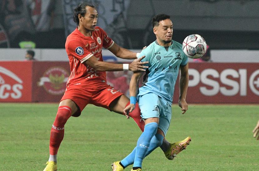 Pesepak bola Madura United FC Luiz Marcelo (kanan) diadang pesepak bola Persija Jakarta Hansamu Yama (kiri) pada pertandingan Liga 1 di Stadion Patriot Chandrabhaga, Bekasi, Jawa Barat, Sabtu (17/9/2022). 