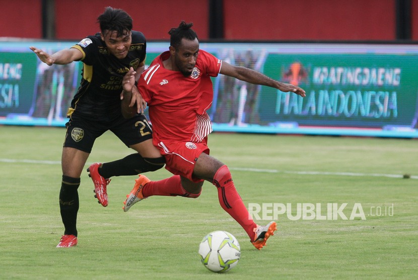 Pesepak bola Persija Jakarta, Frengki Pare Kogoya (kanan) berebut bola dengan pemain Bogor FC, Dian Transiska dalam pertandingan babak 64 besar Piala Indonesia di Stadion Kapten I Wayan Dipta, Gianyar, Bali, Rabu (12/12/2018). 